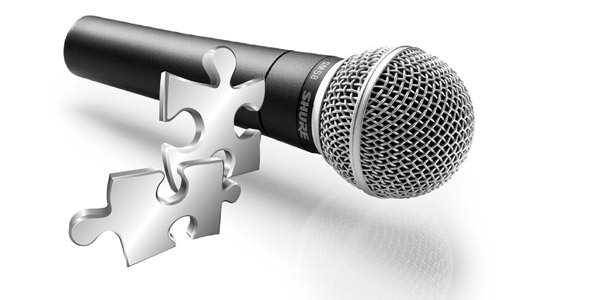 Microphone with puzzle pieces floating in front of it representing topics that could provide clarity for HR challengs